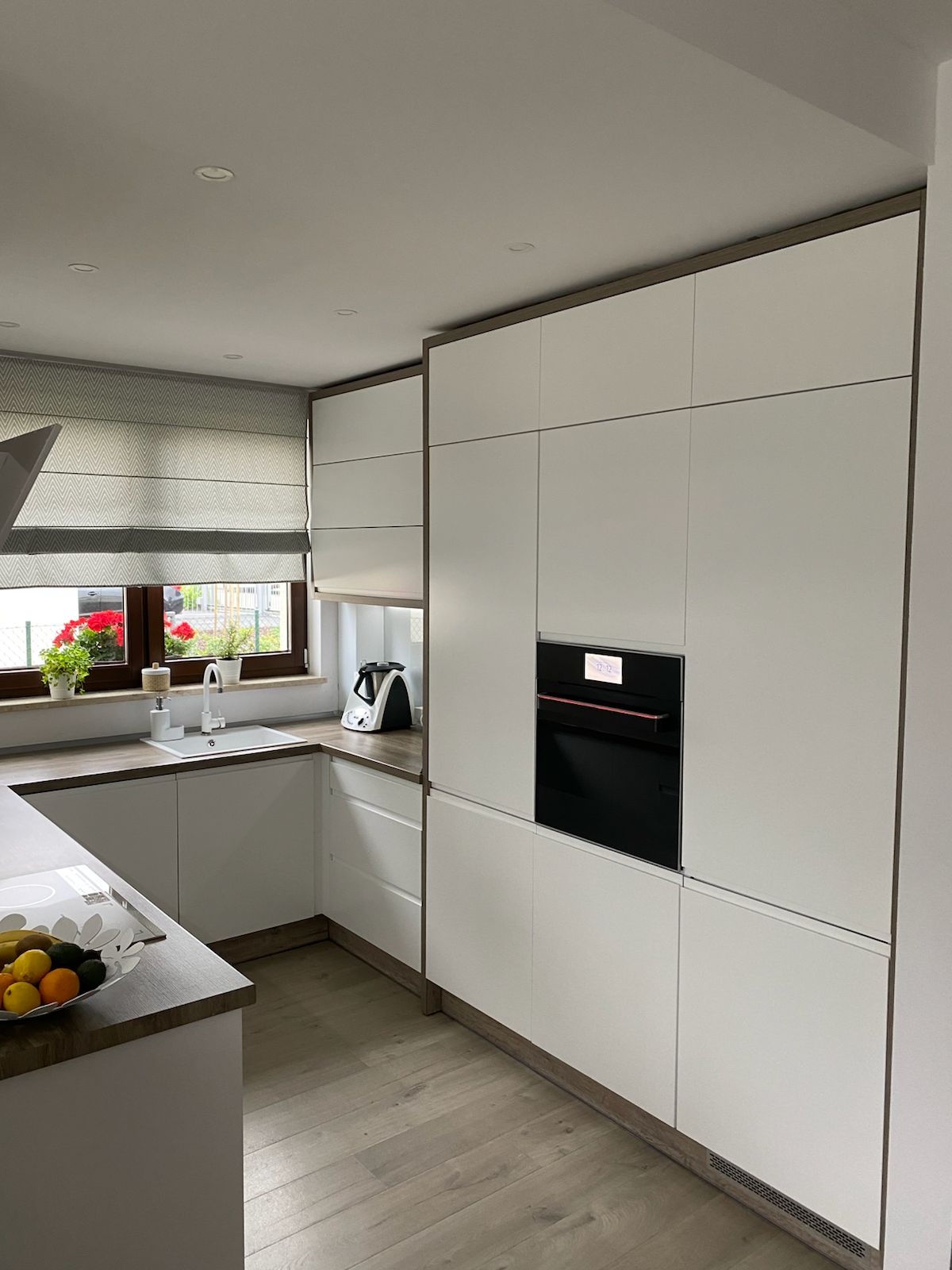 Minimal white fitted kitchen renovation in London