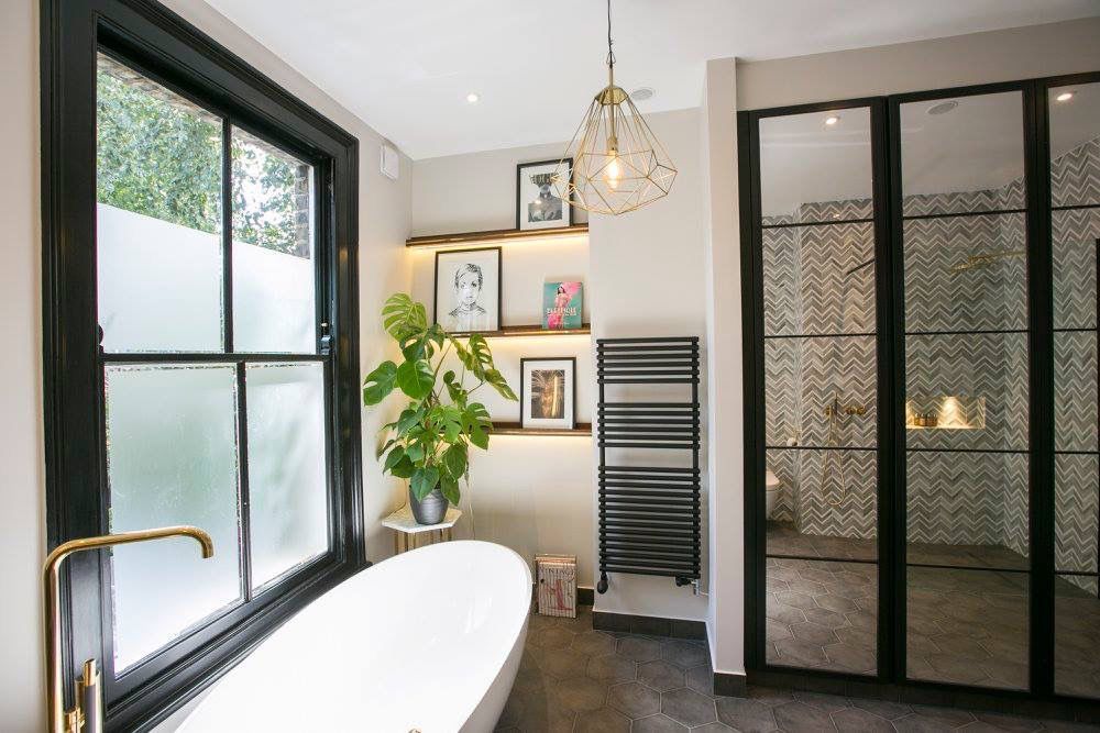 Refined London bathroom renovation with freestanding bath and black-framed shower